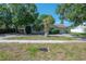 Cozy single-story home featuring mature trees, a large front yard, and a convenient circular driveway at 3256 Adrian Ave, Largo, FL 33774