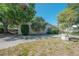A single-Gathering home with a tree, shrubbery, and a driveway at 3256 Adrian Ave, Largo, FL 33774
