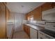 Kitchen features wooden cabinets, tile backsplash, and white appliances at 3256 Adrian Ave, Largo, FL 33774
