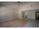 Bright living room features tile and laminate flooring, a ceiling fan, and high ceilings at 3256 Adrian Ave, Largo, FL 33774
