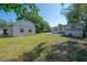 Large backyard with a storage building, deck, and lots of grass at 3258 Adrian Ave, Largo, FL 33774