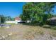 Spacious backyard featuring a large storage building and partially covered deck at 3258 Adrian Ave, Largo, FL 33774