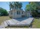 Backyard featuring a weathered wooden deck and a building with siding at 3258 Adrian Ave, Largo, FL 33774