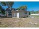 Cottage-style home featuring wood siding and an unkempt front yard ready for landscaping at 3258 Adrian Ave, Largo, FL 33774
