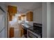A view of the kitchen featuring wooden cabinets and outdated appliances at 3258 Adrian Ave, Largo, FL 33774