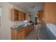 A view of the kitchen featuring wooden cabinets and a black-and-white tiled floor at 3258 Adrian Ave, Largo, FL 33774