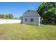 Outbuilding with sliding door and a yard with plenty of grass at 3258 Adrian Ave, Largo, FL 33774