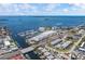 Scenic aerial view of the marina and waterfront community with ocean views and clear blue skies at 340 Causeway Blvd # 104, Dunedin, FL 34698