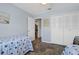 This bedroom features twin beds, a closet, tile floors, and access to a guest bathroom at 340 Causeway Blvd # 104, Dunedin, FL 34698
