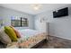 Bright bedroom featuring colorful bedding, a ceiling fan, and a mounted television at 340 Causeway Blvd # 104, Dunedin, FL 34698