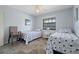 Bright guest bedroom featuring two twin beds, neutral walls, and tile flooring at 340 Causeway Blvd # 104, Dunedin, FL 34698