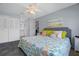 This cozy bedroom offers tile floors, beach-themed decor, and access to an ensuite bath at 340 Causeway Blvd # 104, Dunedin, FL 34698