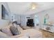 Comfortable living room featuring a plush sofa, entertainment center, and tile flooring at 340 Causeway Blvd # 104, Dunedin, FL 34698