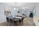 Open-concept living and dining room featuring tile floors and comfortable contemporary furnishings at 340 Causeway Blvd # 104, Dunedin, FL 34698