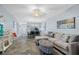 Spacious living area with plush sofa and seamless connection to dining and kitchen areas at 340 Causeway Blvd # 104, Dunedin, FL 34698