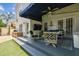 Comfortable seating and a tv are available on this covered back porch, connected to the backyard at 3405 W Palmira Ave, Tampa, FL 33629