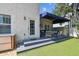 The back porch is partially covered and features modern furniture and access to the backyard at 3405 W Palmira Ave, Tampa, FL 33629