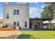 This backyard features artificial turf, outdoor dining, a covered patio, and a built-in outdoor kitchen at 3405 W Palmira Ave, Tampa, FL 33629