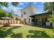 Enjoy the turf backyard, with an outdoor dining table, covered patio, and built in kitchen at 3405 W Palmira Ave, Tampa, FL 33629
