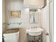 Classic bathroom with a pedestal sink, a chrome framed mirror, and a shower with a white curtain at 3405 W Palmira Ave, Tampa, FL 33629
