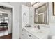 Bright bathroom vanity features white cabinets, white countertops and a large mirror above the sink at 3405 W Palmira Ave, Tampa, FL 33629