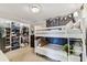 Bright bedroom with white bunk beds and closet with clothing rack at 3405 W Palmira Ave, Tampa, FL 33629