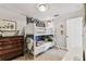 A bedroom features a white bunk bed, dresser, and tasteful decor at 3405 W Palmira Ave, Tampa, FL 33629