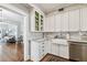 Modern kitchen features white cabinets, farmhouse sink, granite counters and view of the living room at 3405 W Palmira Ave, Tampa, FL 33629