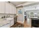 Charming kitchen features a farmhouse sink, stainless steel appliances, and a view into a cozy living space at 3405 W Palmira Ave, Tampa, FL 33629