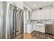 Modern kitchen boasts stainless steel appliances, granite counters, farmhouse sink, and ample cabinet space at 3405 W Palmira Ave, Tampa, FL 33629