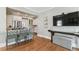 Bright kitchen featuring stainless steel appliances, granite countertops, island with seating, and hardwood floors at 3405 W Palmira Ave, Tampa, FL 33629