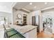 Kitchen island with granite countertop, seating, gas range, and open access to other rooms at 3405 W Palmira Ave, Tampa, FL 33629