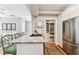 Kitchen island with seating, gas range, stainless refrigerator and pantry in a bright, open floorplan at 3405 W Palmira Ave, Tampa, FL 33629