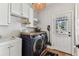 The laundry room has a washer and dryer, sink, and door that leads to the outside at 3405 W Palmira Ave, Tampa, FL 33629