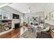 Cozy living room features a fireplace, built-in shelving, and seamless access to the sunroom at 3405 W Palmira Ave, Tampa, FL 33629