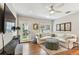 Living room boasts a white couch, hardwood floors and a view of the backyard at 3405 W Palmira Ave, Tampa, FL 33629