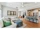 Open-concept living room showcasing a white couch, hardwood floors, and adjacent kitchen at 3405 W Palmira Ave, Tampa, FL 33629
