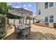 The brick patio offers outdoor dining with a table, umbrella, and comfortable seating for Gathering and friends at 3405 W Palmira Ave, Tampa, FL 33629