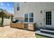 Backyard features an outdoor kitchen, including a grill and beverage refrigerator, next to the house at 3405 W Palmira Ave, Tampa, FL 33629
