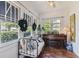 Cozy sunroom featuring a daybed, piano, and tile flooring at 3405 W Palmira Ave, Tampa, FL 33629