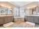 Main bathroom features dual sinks, soaking tub with tile surround, and wood-look tile flooring at 3656 Kalanchoe Pl, Wesley Chapel, FL 33544