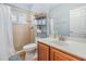 Well-lit bathroom featuring tiled walk-in shower, a sleek sink, and handy shelving for efficient organization at 3656 Kalanchoe Pl, Wesley Chapel, FL 33544