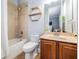Bathroom featuring a combined bathtub and shower with tiled walls, vanity with storage, and modern fixtures at 3656 Kalanchoe Pl, Wesley Chapel, FL 33544