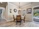 Cozy breakfast nook with wood-look tile floors, glass table, and views of the screened in pool at 3656 Kalanchoe Pl, Wesley Chapel, FL 33544