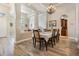 Open dining room features a chandelier, decorative columns, and access to the kitchen at 3656 Kalanchoe Pl, Wesley Chapel, FL 33544