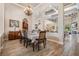 Elegant dining room with an ornate chandelier, tiled floor, and easy access to the living room and kitchen at 3656 Kalanchoe Pl, Wesley Chapel, FL 33544