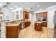Well-lit kitchen boasts granite countertops, stainless steel appliances, wood cabinets, and a center island at 3656 Kalanchoe Pl, Wesley Chapel, FL 33544
