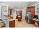 Spacious kitchen features wood cabinets, granite countertops, stainless steel appliances, and center island at 3656 Kalanchoe Pl, Wesley Chapel, FL 33544