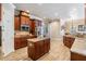 Charming kitchen features granite counters, center island, stainless appliances, and ample wood cabinets at 3656 Kalanchoe Pl, Wesley Chapel, FL 33544