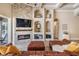 Beautiful living room with stacked stone fireplace, built in storage, and seamless access to backyard pool at 3656 Kalanchoe Pl, Wesley Chapel, FL 33544